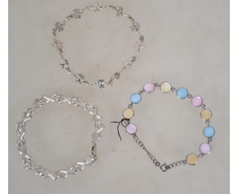 A group of three sterling silver 925 bracelets one being of x link form with a lobster claw clasp, one having pixie / fairy l