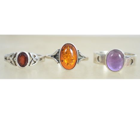 A group of sterling silver 925 dress rings, one set with purple amethyst, one set with amber cabochon, and one set with garne