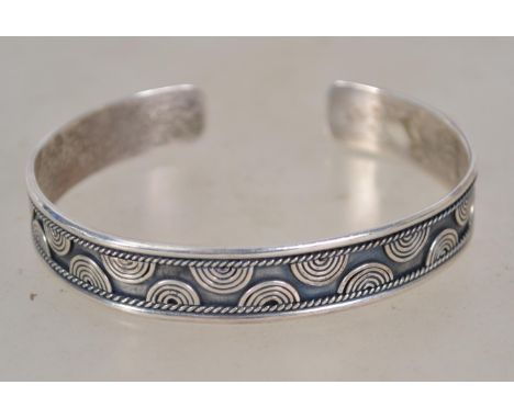 A contemporary sterling silver bangle bracelet marked 925. Weighs 18.9 grams.