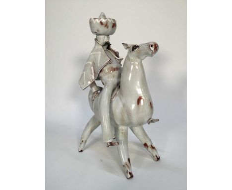 Stanislas Reychan(1897-1994) studio pottery figure of a man on horseback, together with related article, 36cm high
His cape i