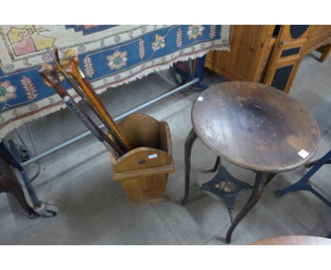 A Victorian ebonised and painted occasional table and a stick stand with sticks