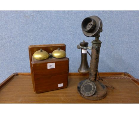 A vintage candlestick telephone and bell box