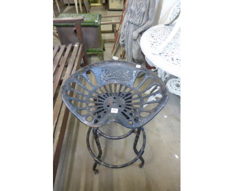 A steel and cast iron swivel top tractor seat stool
