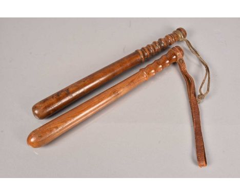 A Military issue wooden truncheon, stamped to the pommel, with broad arrow and 'KA 5498' by W.C & S 54', with leather wrist s