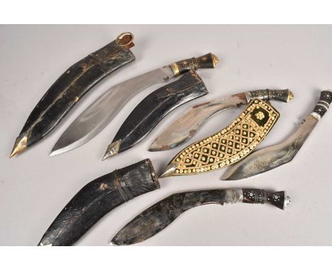 A group of four Middle Eastern Kukri knives, all different sizes, with scabbard, missing smaller knives (8)