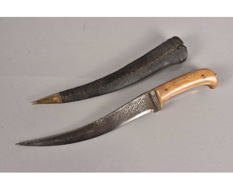 An Indo-Persian Peshkabz knife, having 24cm long curved blade, with chiselled decoration to either side of the blade, also de