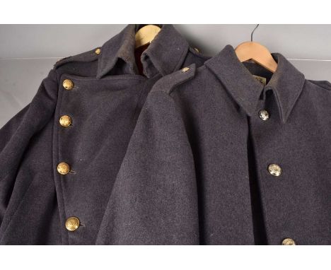 Two blue Coldstream Guards Great Coats, of different design, one having Warrant Officer Class 2 bullion badges to the epaulet