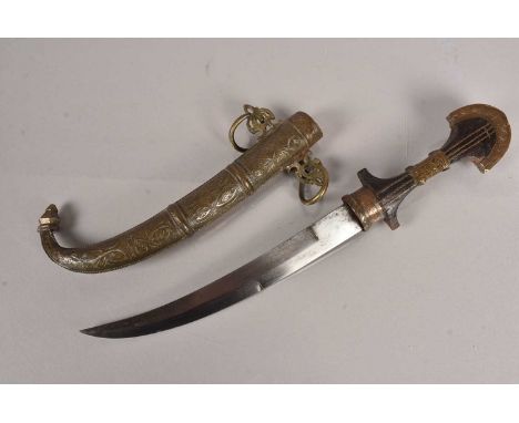 A Moroccan Jambya or Koummya, having 24cm long blade having inside and outside cutting edge, with wooden grip with metal deco