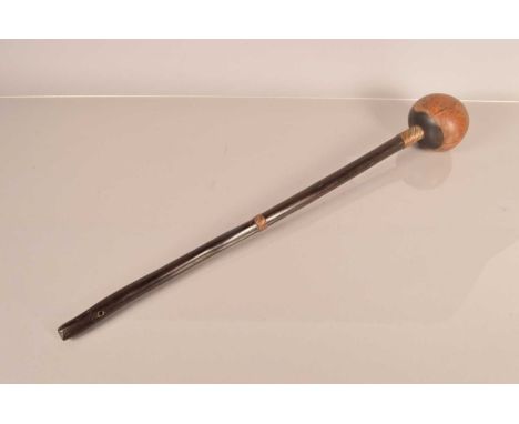 An African Hardwood Knobkerrie, having 61cmcm long shaft, with two wire bound collars, with hole to the terminal, with bulbou