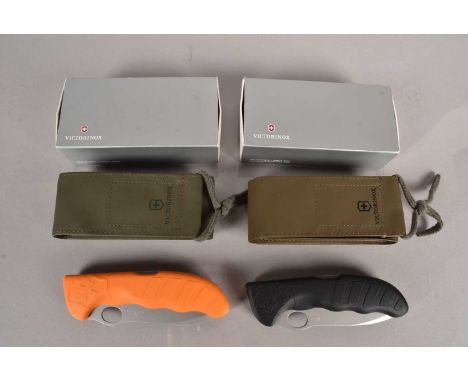 Victorinox - HunterPro knives, one in orange, the other in black, complete with there carry cases and cardboard retailers box