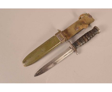 A US M3 Combat/Fighting knife by Imperial, having makers name to the blade, leather washer grip, complete with M8A1 scabbard 