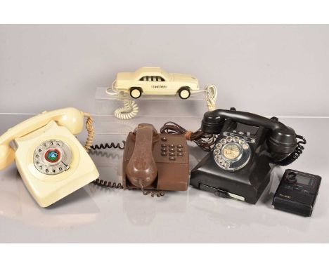 A group of vintage telephones, to include a black Bakelite example (328F PL.56/2A), one in cream (746F PLU 71/1), a Betacar, 