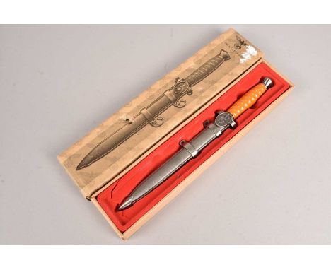 A Reproduction German Red Cross dagger, complete with scabbard and retailers box, please form own opinion before bidding