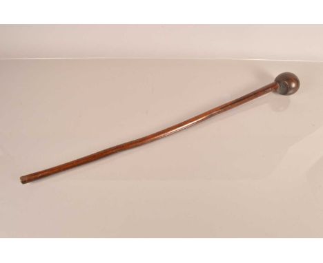 An African Hardwood Knobkerrie, having 70.5cm long shaft, with bulbous end, 7cm in diameter, the head having chamfered top an