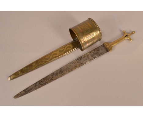 An African Arm Dagger, having 36cm long double edged blade, with decoratively engraved brass grip and scabbard with arm band,