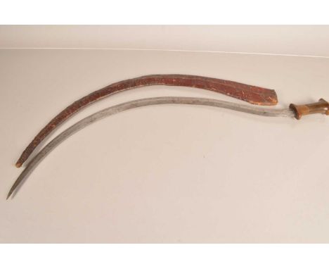 A 19th Century Ethiopian Shotel sword, having an 85cm long double edged crescent blade, with two piece horn handle, with bras