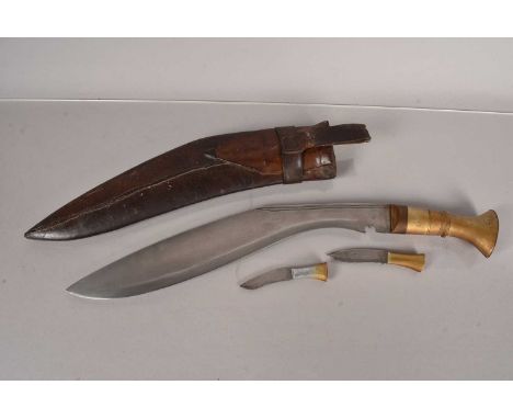 A brass handled Middle Eastern Kukri knife, having 38cm long blade, with double fuller to the back of the blade, complete wit