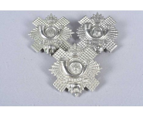 Highland Light Infantry, three badges, comprising Victorian, King's and Queen's Crown, all with two loops (3)