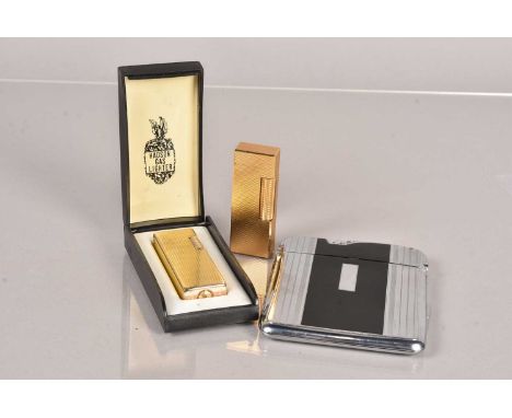 A gold plated Dunhill pocket lighter, patent 24163, having engine turned design, together with a similar Hadson Rodeo, and an