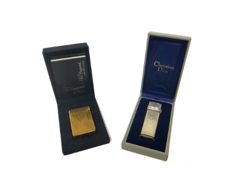 A Christian Dior Paris silver plated curved rectangular gas lighter, with plastic guarantee card, booklet, case and box and a