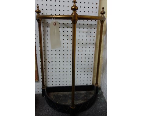 A Victorian tubular brass and cast iron four division stick stand of demi-lune form (60cm high) and a brass folding coat rack