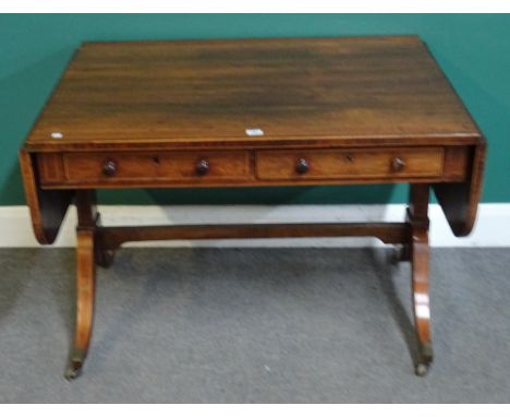 A Regency faux satinwood banded rosewood sofa table, with a pair of frieze drawers on trestle end standards and four downswep