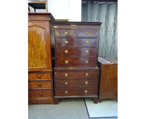 A George III mahogany chest on chest of two short and three long graduated drawers, a brushing slide and three long drawers, 