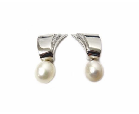 A pair of white gold, diamond and cultured pearl earclips, each of geometric design, the top mounted with circular cut diamon