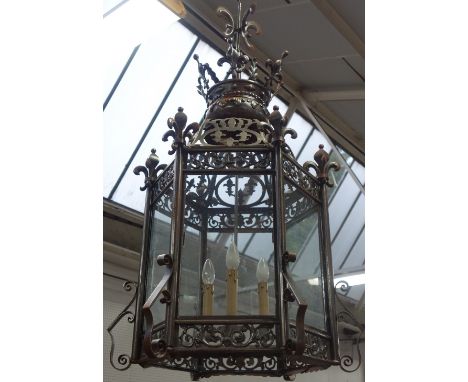 A Victorian style sheet steel hanging lantern, late 20th century, of hexagonal form, with fleur-de-lys crown surmount over a 