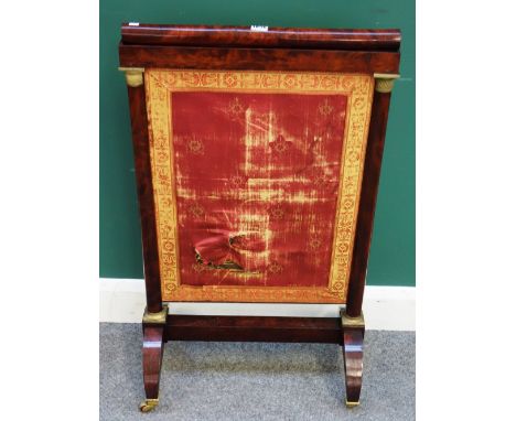 A French Empire gilt metal mounted mahogany height adjustable fire screen, on four downswept supports, 55cm wide x 92cm high 