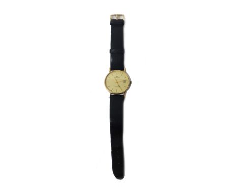 A Garrard Quartz 9ct gold circular cased gentleman's wristwatch, the signed gilt dial with gilt baton numerals, centre second