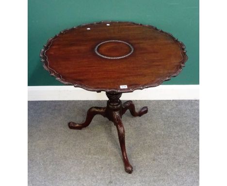 A George III mahogany occasional table, the pie-crust snap top on birdcage mount and carved tripod base, 84cm diameter x 71cm