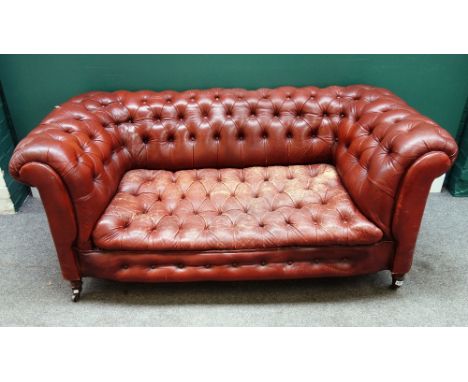 An early 20th century tan button back leather upholstered Chesterfield sofa, on turned supports, 170cm wide x 70cm high x 80c