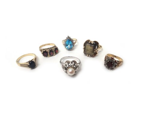 A cultured pearl and rose diamond set ring, in a pierced design, a gold and garnet set three stone ring, mounted with a row o