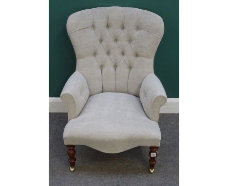 A modern button back armchair, of mid 19th century style, on turned supports, 67cm wide x 95cm high.