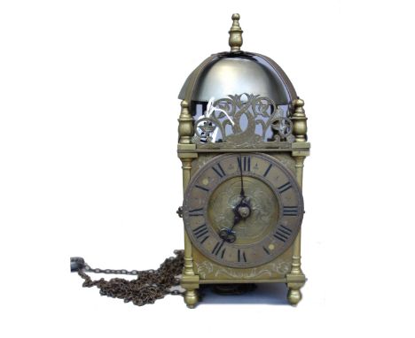 A brass lantern clock, the bell over a posted frame, the dial engraved with a Tudor rose, the movement with countwheel strike