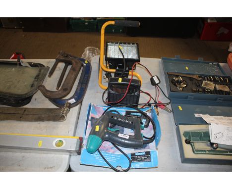 A Rapesco electric stapling tacker with original box, a 4amp battery charger and work light