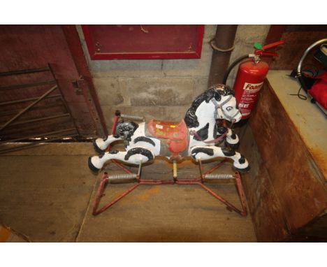 A vintage metal painted child's rocking horse