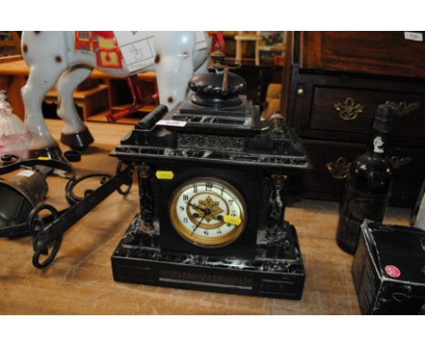 A black slate two hole mantel clock