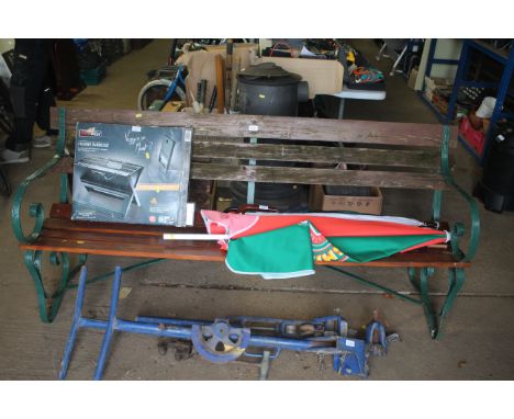 A wooden and metal framed garden bench with scroll ends