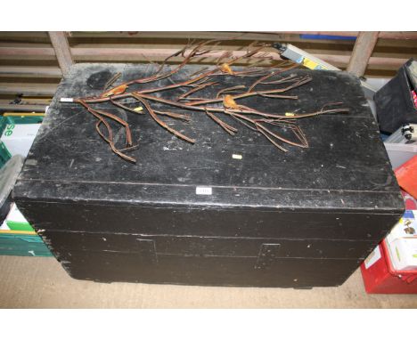 A large wooden black painted storage trunk