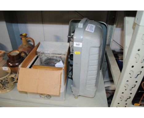 A Tower 8mm projector, sold as collector's item, and a box of reels