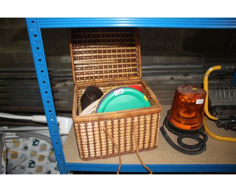 A wicker picnic hamper and contents of plastic plates, cups, etc
