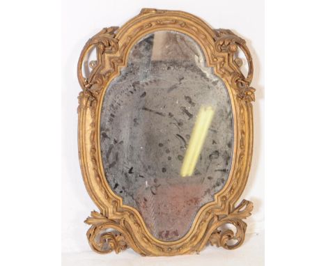 A vintage 20th century giltwood 1920s wall hanging mirror. With carved scrolled decoration, with hard wood back and writing&n