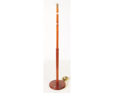 British Modern Design - A mid 20th century teak wood floor standing standard lamp. The lamp on a turned rounded base, with tu