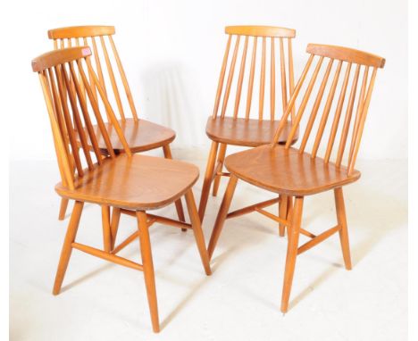 A set of four mid 20th century beech and elm stick back kitchen dining chairs. The chairs having a stick back design, with th