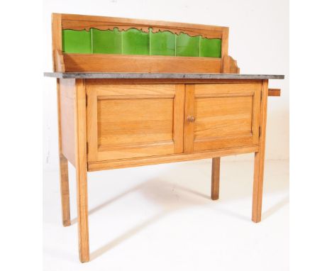 Edwardian Arts and Crafts manner oak wood washstand. The washstand raised on squared legs, with cupboard doors to front. Havi