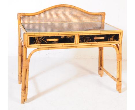 A vintage 20th century bamboo and rattan desk. The desk having a raised shaped gallery back above an ebonised top featuring f