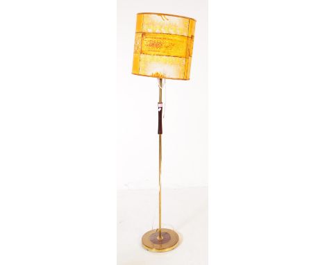 A mid 20th century Danish manner brass and wood floor standing standard lamp. The lamp featuring a round brass base, with woo