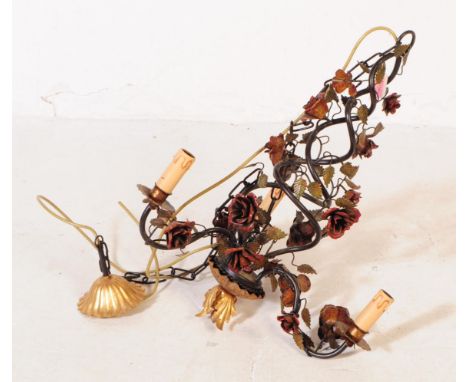 An Italian inspired three arm cage toleware chandelier ceiling light. The light having a twin spiral body decorated with rose